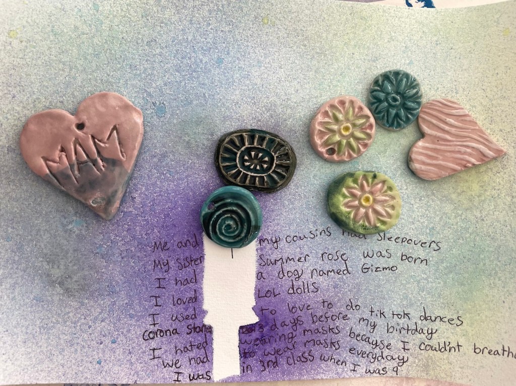 a drawing with a silouhette of a child titled  "when I was 9" with text and some ceramic tiles scattered on the surface